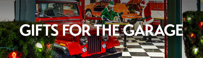 Classic red car in a festive garage decorated for Christmas with the words 'Gifts for the Garage' — premium car care tools and garage gifts from Griot's Garage. 