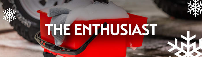 Red wash bucket filled with suds and microfiber towels with the words 'The Enthusiast' — perfect holiday car care gift ideas for the dedicated car lover from Griot's Garage.